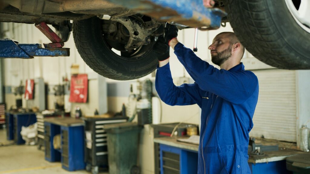 Imagen de un mecánico realizando un cambio de piezas a un coche Subaru